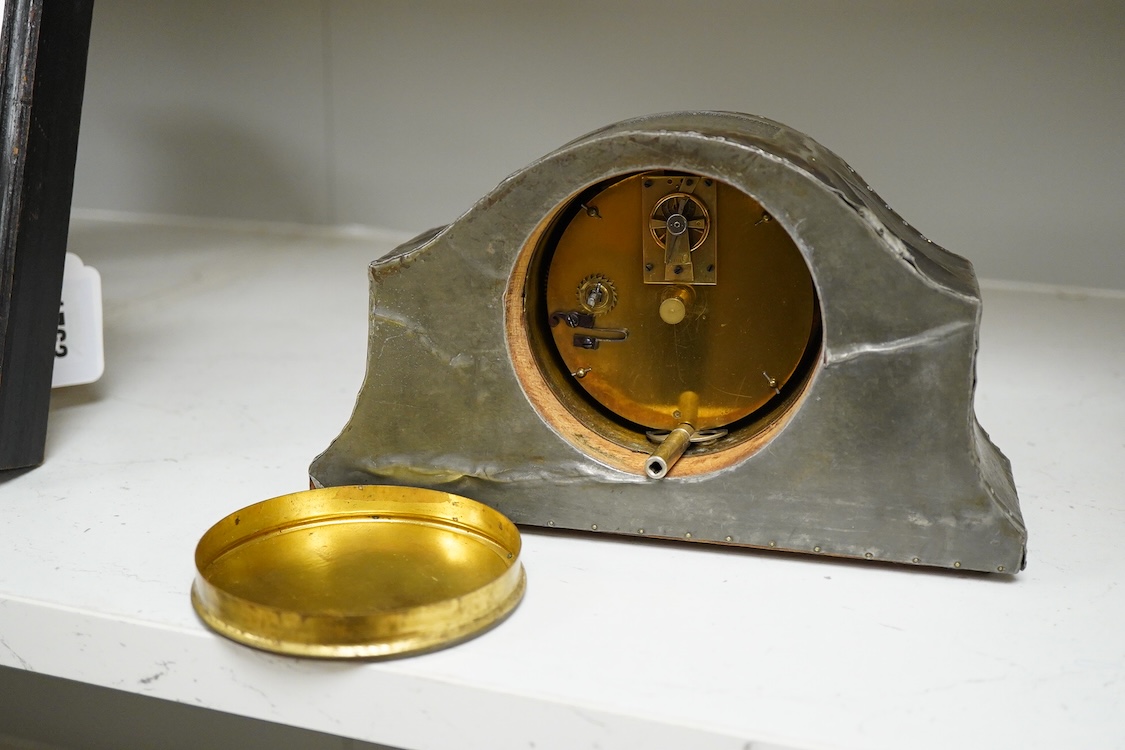 A pewter mantel timepiece with key, 22cm wide